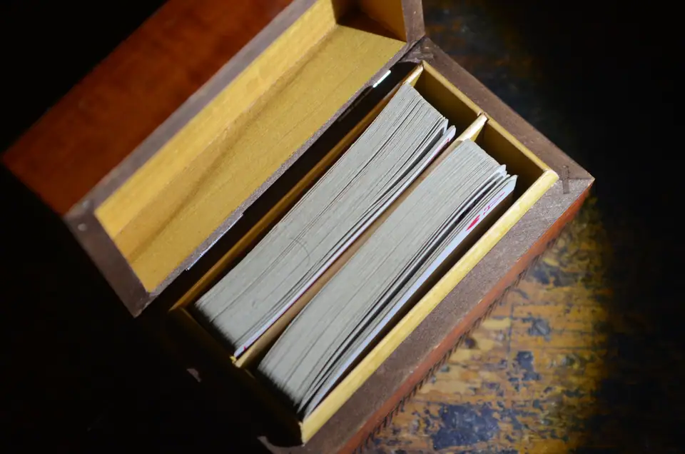 Two decks of playing cards stored in an open wooden box